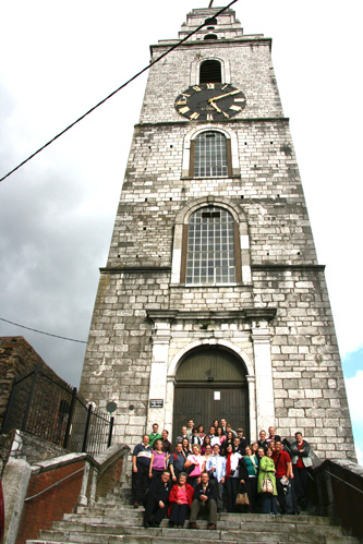 Some of the choir in front of same tower as above